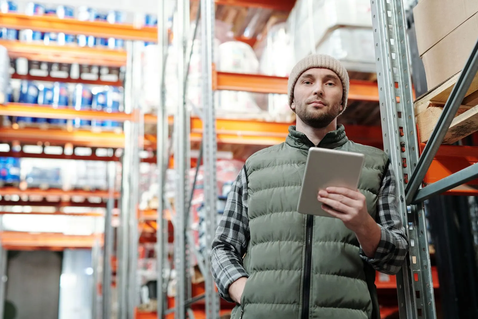 A warehouse manager reviewing stock figures on a tablet